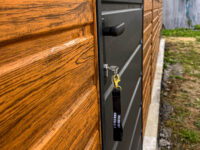 Garaż blaszany dwuspadowy 3 m x 8 m Multigloss z ażurową wiatą zbliżenie na drzwi