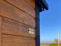 Wiata garażowa dwuspadowa 6 m x 5,8 m Multigloss z pomieszczeniem gospodarczym zbliżenie na okucie i wizytówkę